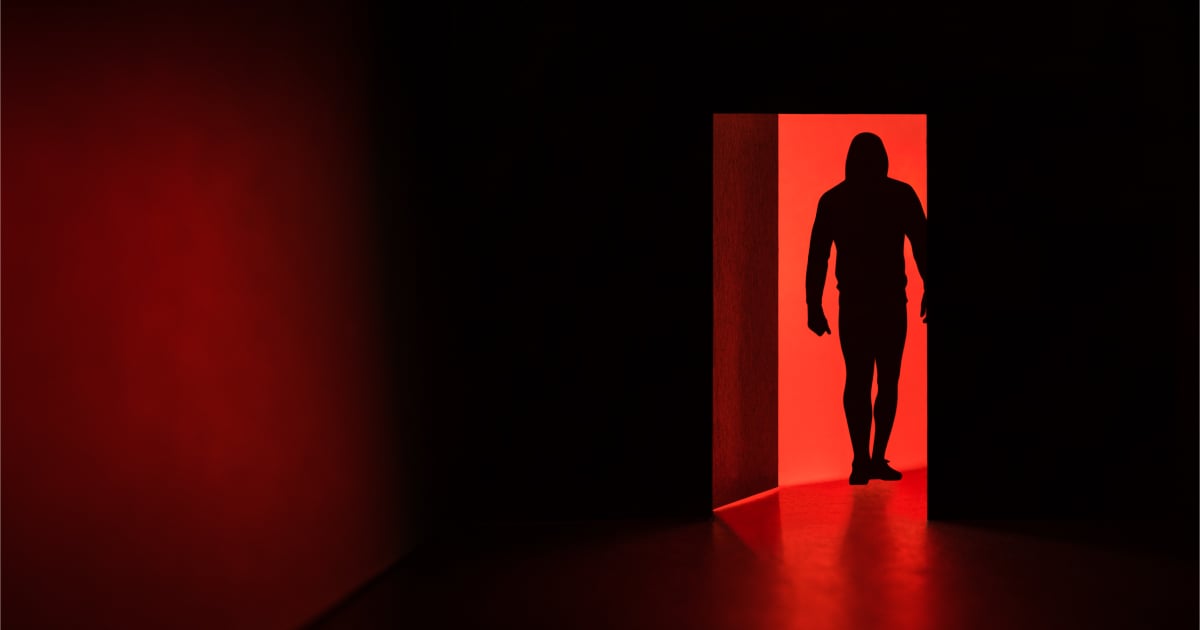 Dark hooded figure security getting physical