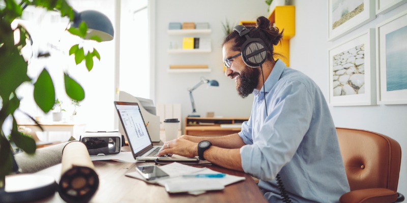 Bearded chap working from home on his laptop 